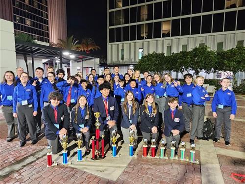 TSA Students displaying the trophies they won at the Florida TSA Conference.