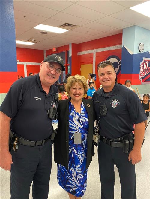 Bradenton Police Officers take a picture with Principal Gonzales