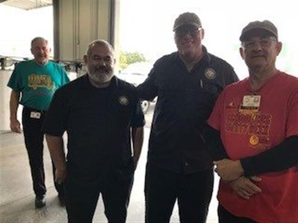 mechanics pose for a photo