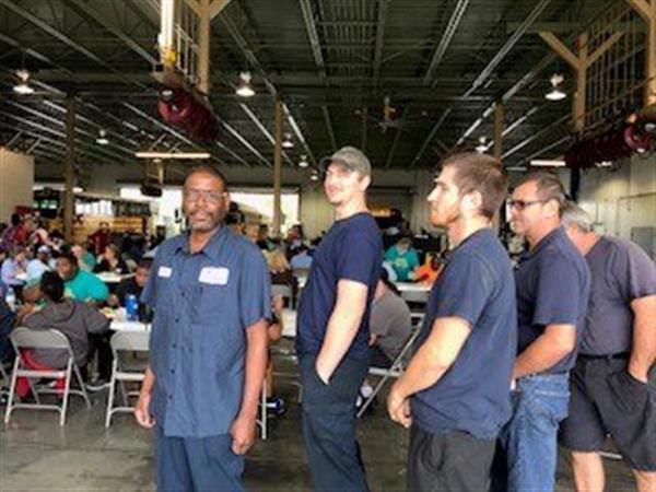 mechanics in buffet line smile for photo