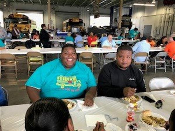 smiling staff eat lunch together
