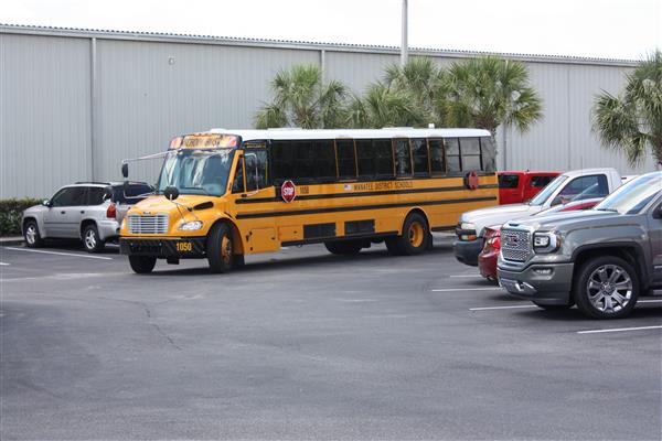 yellow school bus entering parking lot