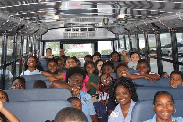 happy students inside a school bus